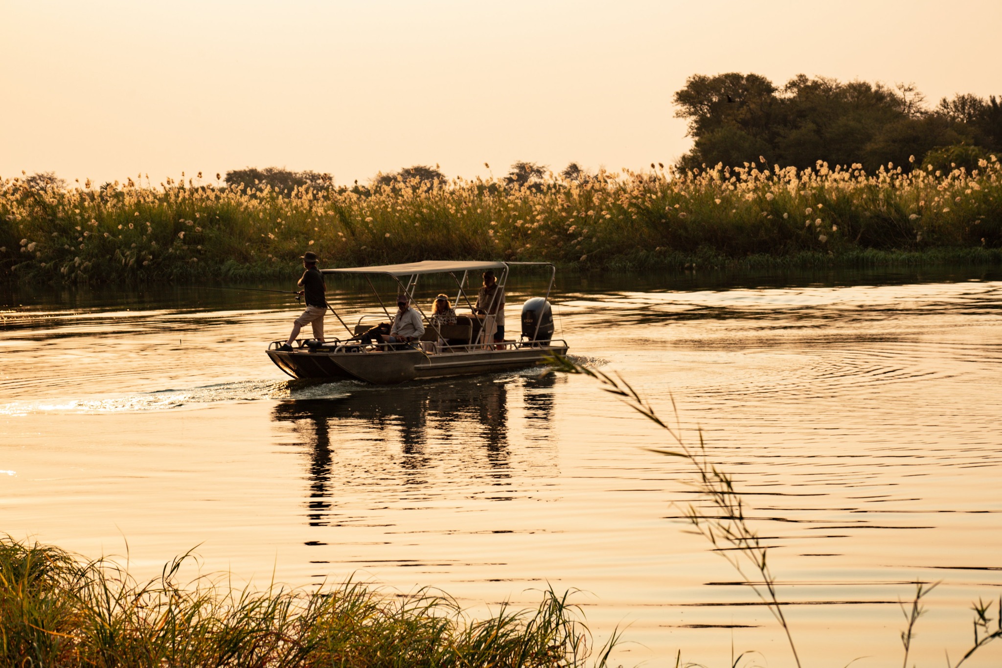 Guests aboard a small boat on the Okavango River