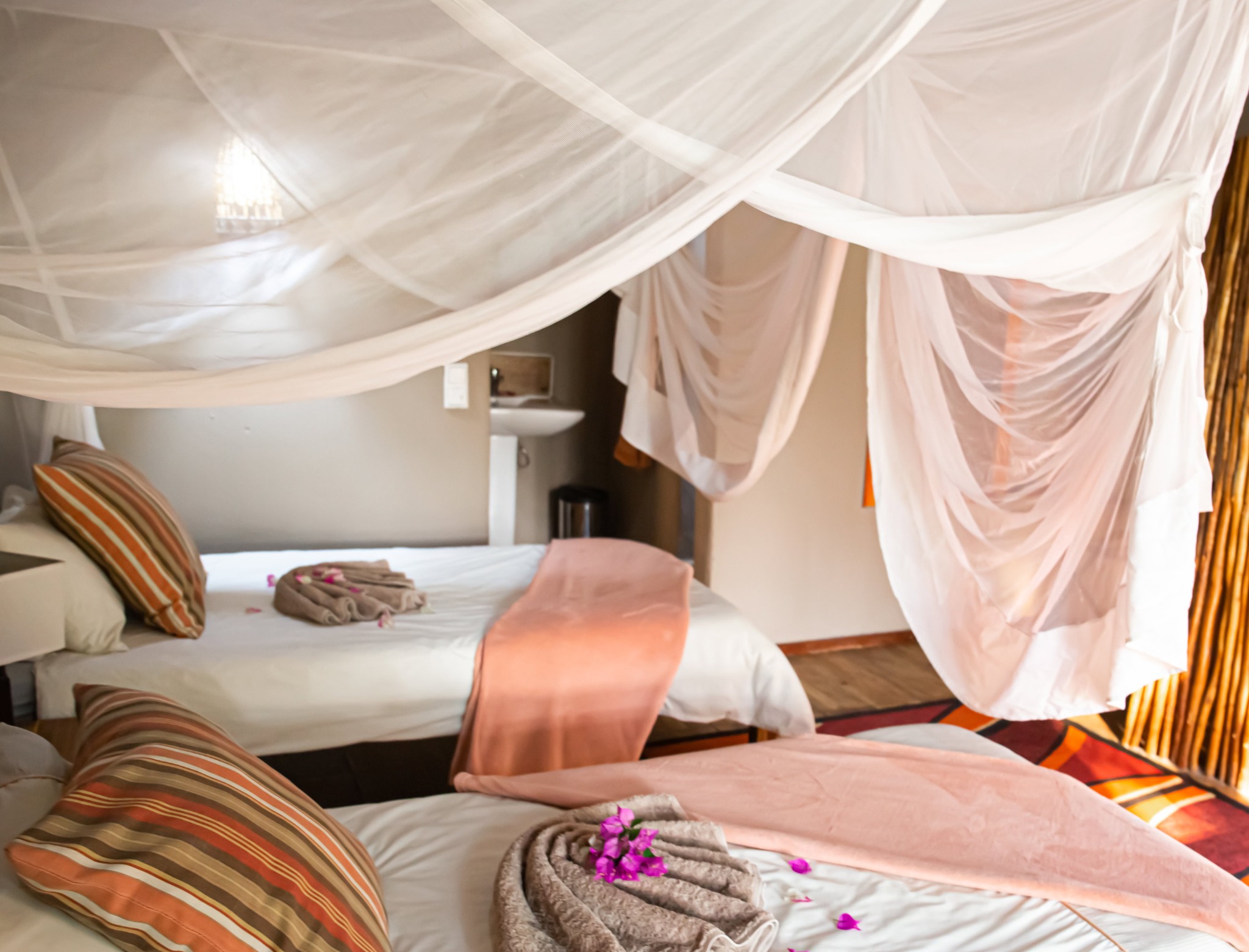 Twin beds with mosquito nets in a Kayova chalet