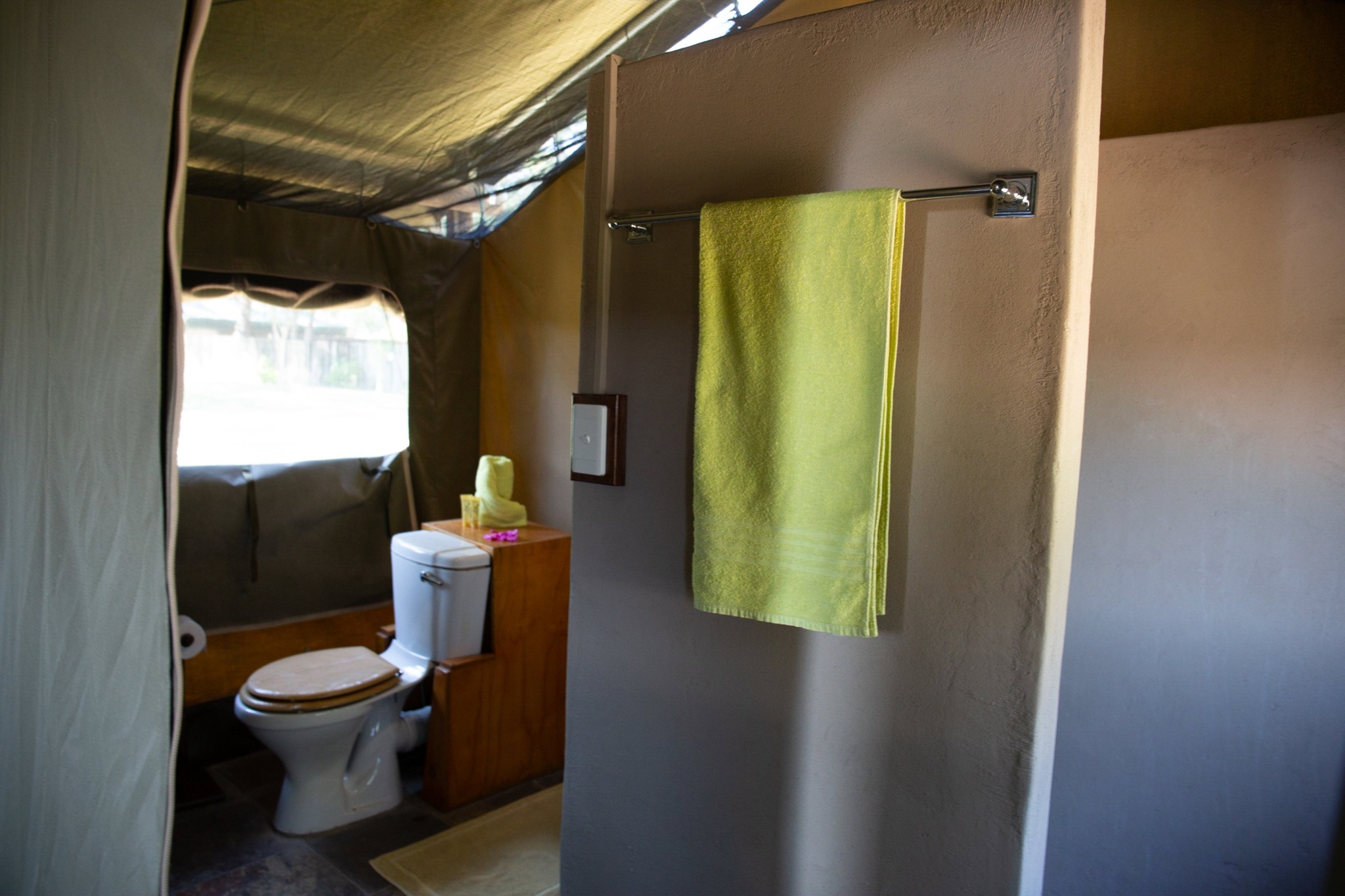 Shower and toilet within a safari tent bathroom